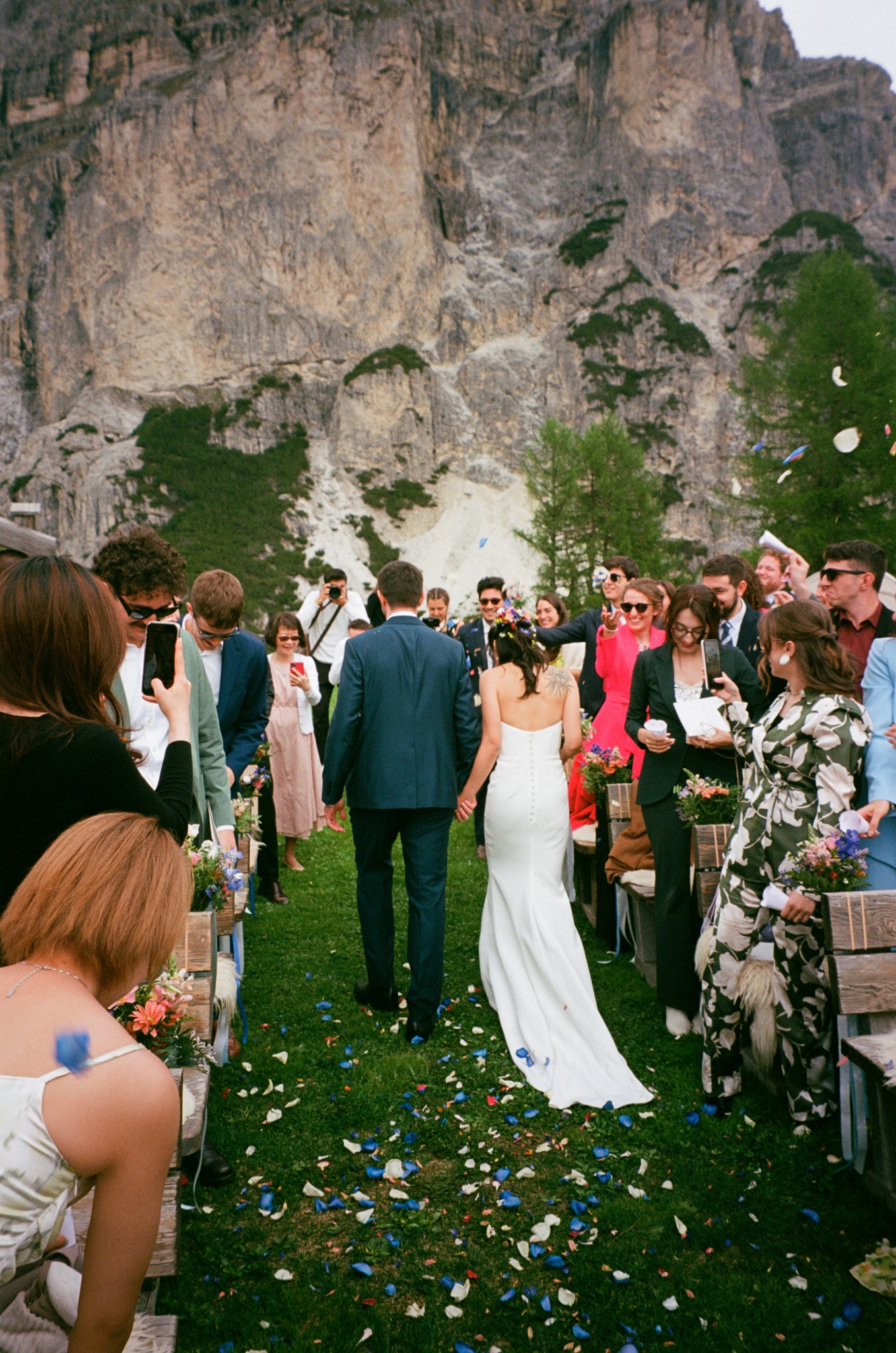 Wedding guests gathered around a couple outdoors